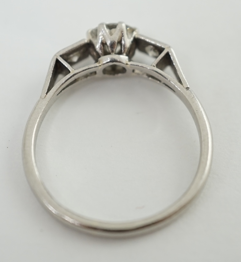 A 1920's/1930's platinum and single stone diamond set ring, with two stone diamond set shoulders